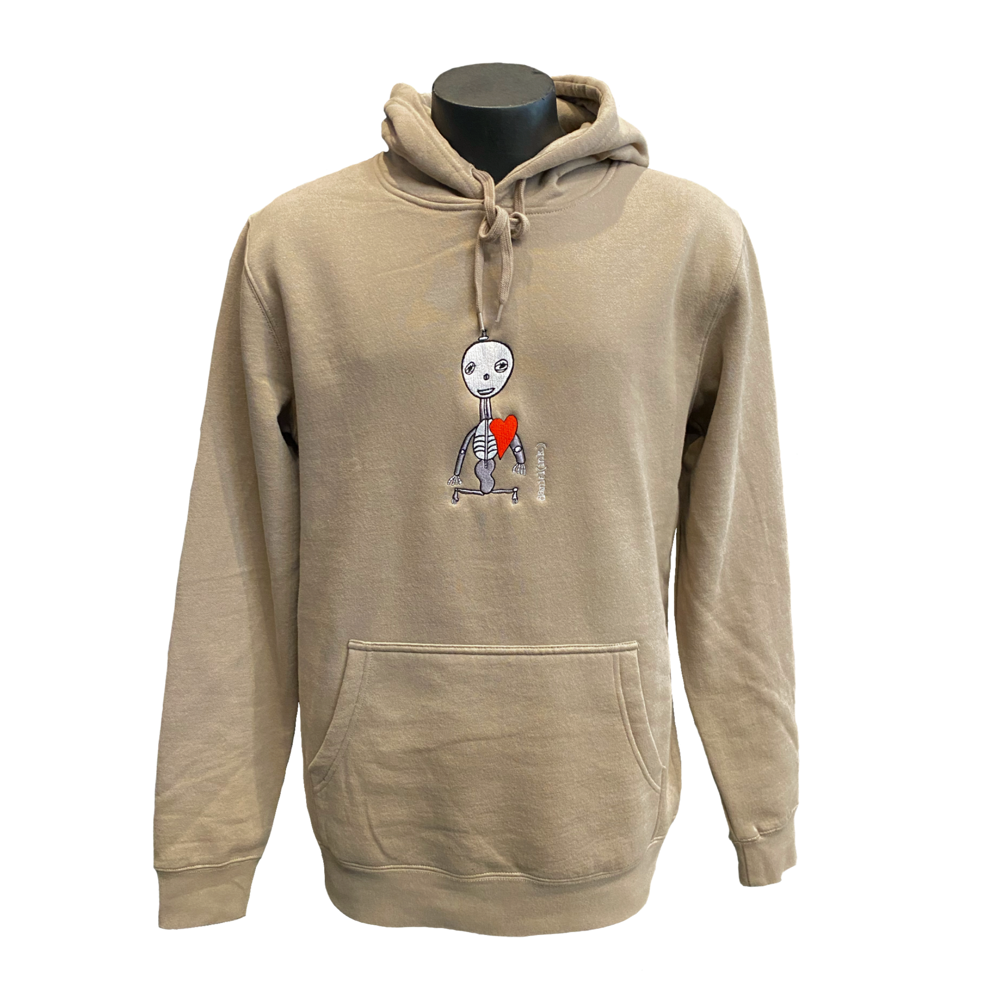 Unisex sand-coloured hoodie featuring an embroidered image of a silver skeleton with a red heart. The name daniel(ink.) is embroidered in silver thread next to the skeleton.